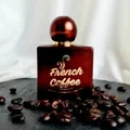 Bronze bottle labeled 'French Coffee' with coffee beans and white flowers on a light background