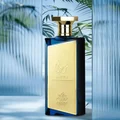 Perfume bottle with gold and blue design against a blurred natural background