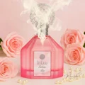 Pink perfume bottle with decorative top surrounded by pink roses on a light pink background