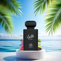 Black perfume bottle labeled 'Al Layl' with palm leaves and ocean in the background