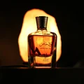 Perfume bottle with a warm glow on a dark background