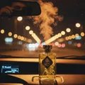 Men perfume bottle on car dashboard at night with vanilla mist and Kuala Lumpur city lights – Al Dirgham men fragrance