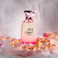 Hareem Al Sultan 100 ml EDP – Perfume bottle with pink ribbon on a soft, blurred background