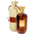 Brown perfume bottle with gold cap and label, accompanied by a matching drawstring bag on a white background.