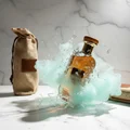 erfume bottle broken, icy mint fog emerging; studio on white marble Malaysia — clear bottle and box, cinematic lighting.