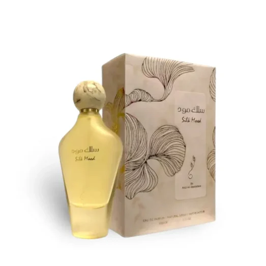 Gold perfume bottle and packaging with floral design on a white background