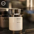 White and gold bottle of Odyssey Homme White Edition by Armaf on a blurred background