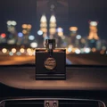 Dubai Nights Midnight by Armaf in car at night with city lights