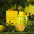 Odyssey Limoni perfume bottle and packaging on a grassy background with lemons