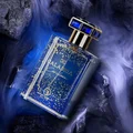 Blue perfume bottle with gold accents on a dark, smoky background
