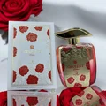Opulent perfume bottle and packaging with red roses on a white background