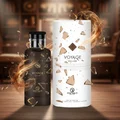 Voyage Exclusif perfume bottle and packaging on a wooden surface with a blurred background