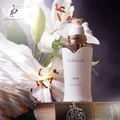 Stellar Musk perfume bottle by Khadlaj with white lilies in the background
