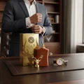 Al Noble Wazeer by Lattafa perfume bottle and box on leather executive desk luxury men scent