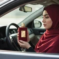 pemandu hijab woman holding Ameerat Al Arab in car