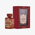Red perfume bottle with intricate gold designs and matching red packaging on a white background