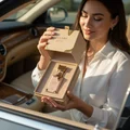 Woman in Car with Eclaire perfume bottle and packaging