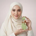 n hijab woman holding eclaire pistache feminine