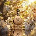 Gold perfume bottle with intricate design surrounded by white flowers