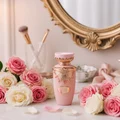 Haya by Lattafa women perfume on vanity with pink white flowers romantic femininee