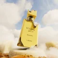 Gold perfume bottle labeled 'Eclaire' with clouds and sand in the background