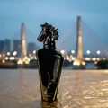Maahir Black Edition with Putrajaya bridge at twilight, soft blue and gold glow, premium elegantt vibe