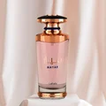 Perfume bottle with rose gold cap and pink body on a white background