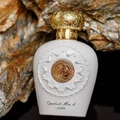 Opulent perfume bottle with gold accents on a textured stone background