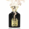 Black perfume bottle with gold cap and label on a white background