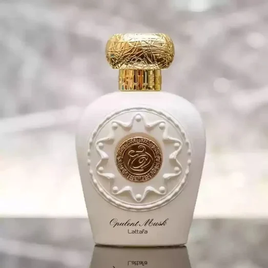 Opulent Perfume bottle with gold cap and intricate design on a blurred background