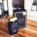 Perfume bottle and packaging on a wooden surface lattafa perfumes