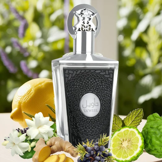 taweel lattafa Perfume bottle with decorative elements like lemons, flowers, and herbs on a blurred natural background