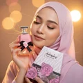 Malay woman hijab holding Washwashah Lattafa perfume women
