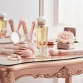 Athena on vanity table with makeup brushes, pink tones, gentle lighting vanity table warna pink