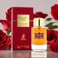 Exclusif Rose perfume bottle and packaging with red roses in the background