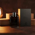 Expose Intense on deep brown leather with cedar blocks and warm amber lamp; Malaysian boutique; clear product.
