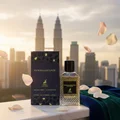 Extravagant Lover on marble balcony with KL skyline bokeh, velvet drape and floating rose petals; bottle and box clearly visible.