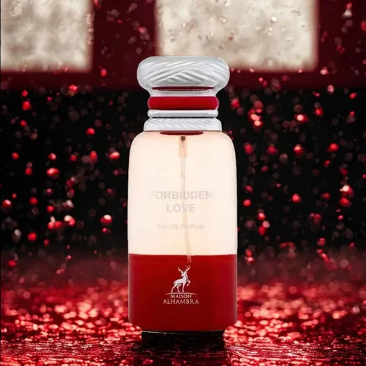 Perfume bottle labeled 'Forbidden Love' with a red and white design on a red glittery background.