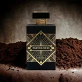 Perfume bottle labeled 'Infini Oud' with gold accents on a textured brown background