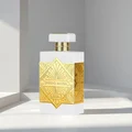 Perfume bottle with gold and white design on a light background