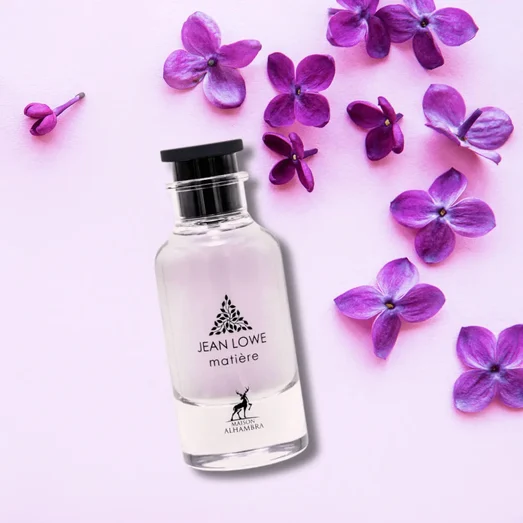 Jean Lowe perfume bottle with purple flowers on a light pink background