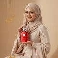 Hijabi holding Kalos Perfume Woman – style sopan feminine