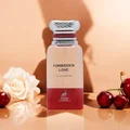 Perfume bottle labeled 'Forbidden Love' with a white rose and cherries on a peach background