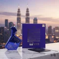Blue perfume bottle and packaging with city skyline in the background