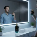 Malay man applying Glacier Bold in front of LED mirror with cool blue glow, fresh clean masculine mood