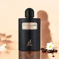 Black perfume bottle labeled 'Opera Noir' with flowers and stones on a beige background
