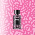 Perfume bottle labeled 'MOOD' on a pink patterned background