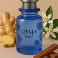Blue Osma Floral'A perfume bottle with ginger, cinnamon, and flowers on a beige background