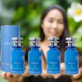 Blue Osma perfume bottle and packaging with ingredients displayed on a light blue background
