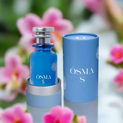 Blue perfume bottle with silver cap and cylindrical container on a white background